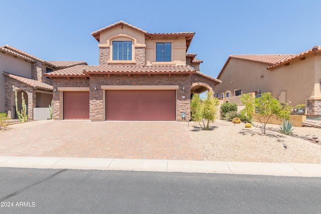 mediterranean / spanish home featuring a garage