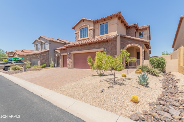 mediterranean / spanish-style house with a garage