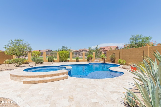 view of pool with a patio area and an in ground hot tub