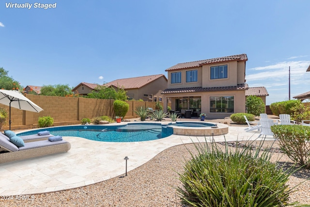 view of pool featuring an in ground hot tub and a patio area