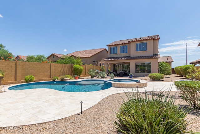 view of pool featuring an in ground hot tub and a patio