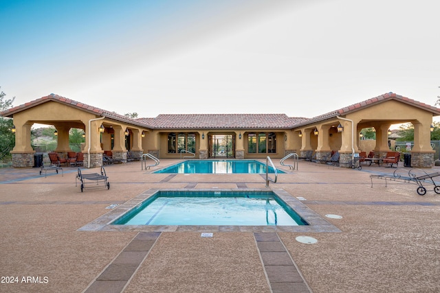 view of swimming pool with a community hot tub and a patio