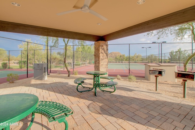 view of patio with tennis court and ceiling fan