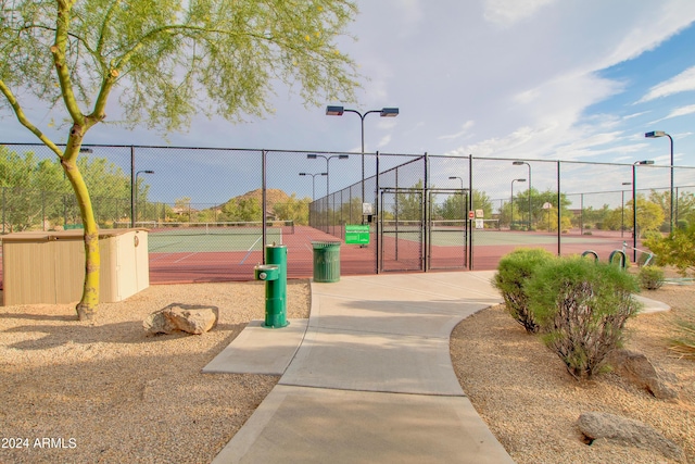 view of community featuring tennis court