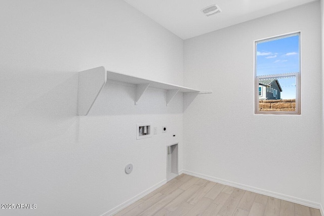 washroom with laundry area, gas dryer hookup, hookup for a washing machine, light wood-type flooring, and electric dryer hookup