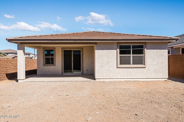 back of property featuring a patio area, fence, and stucco siding