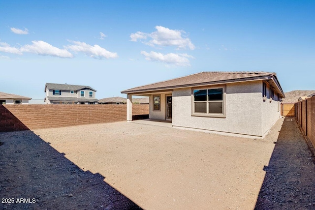 back of house featuring a patio area, a fenced backyard, and stucco siding