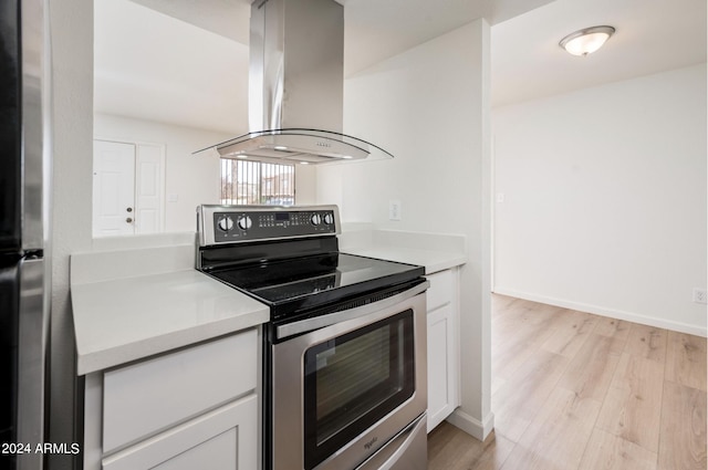 kitchen with light hardwood / wood-style flooring, island range hood, white cabinets, and stainless steel appliances