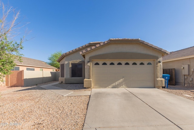 6829 E San Tan Way, Florence, AZ 85132 - view of front of property featuring concrete driveway, stucco siding, a garage, a tiled roof, and fence