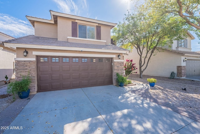 view of front facade featuring stone siding, an attached garage, driveway, and stucco siding