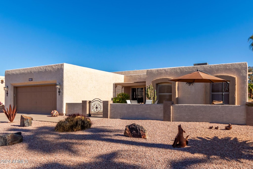 southwest-style home featuring a garage