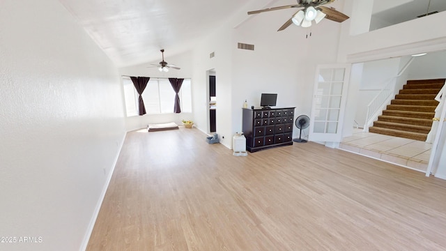 8541 W Pershing Ave, Peoria, AZ 85381 - unfurnished living room featuring a ceiling fan, high vaulted ceiling, light wood-type flooring, and stairs