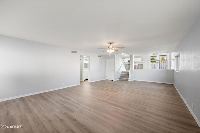 unfurnished living room with hardwood / wood-style floors and ceiling fan