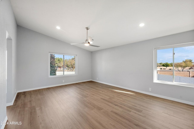 unfurnished room featuring light wood-type flooring, vaulted ceiling, and ceiling fan