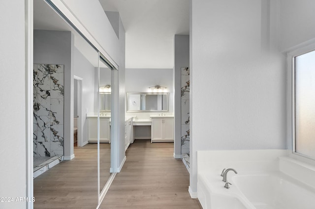 full bathroom featuring vanity, hardwood / wood-style flooring, toilet, and independent shower and bath