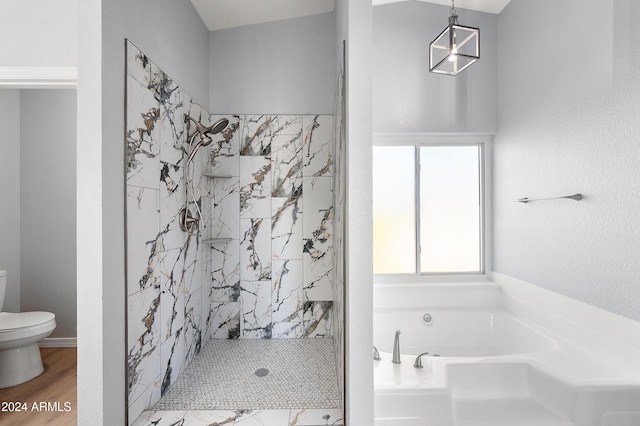 bathroom with hardwood / wood-style floors, toilet, and shower with separate bathtub