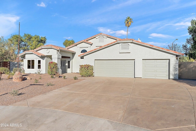 mediterranean / spanish-style house with a garage