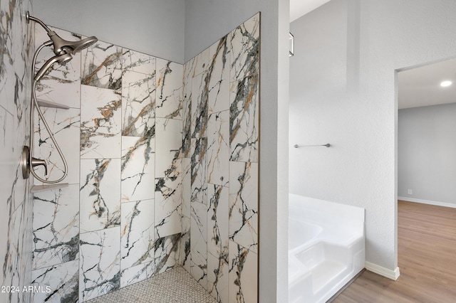 bathroom with hardwood / wood-style floors and independent shower and bath