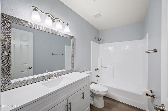 full bathroom featuring vanity, hardwood / wood-style flooring, toilet, and shower / bathtub combination