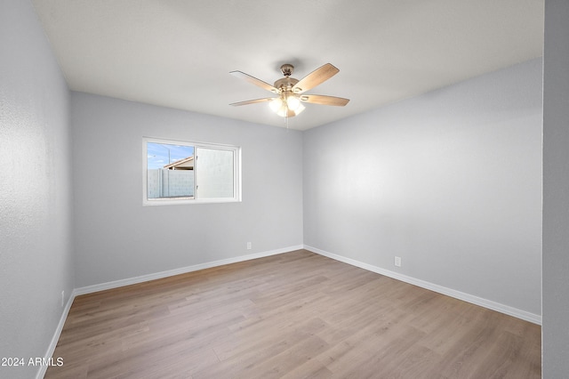 empty room featuring ceiling fan and light hardwood / wood-style flooring