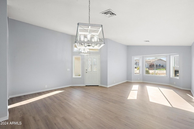 interior space with hardwood / wood-style floors and vaulted ceiling