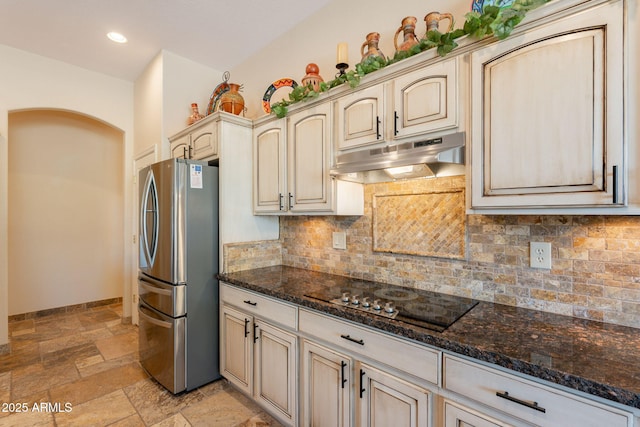 6931 S Four Peaks Way, Chandler, AZ 85249 - kitchen featuring freestanding refrigerator, black electric cooktop, under cabinet range hood, stone tile floors, and cream cabinets