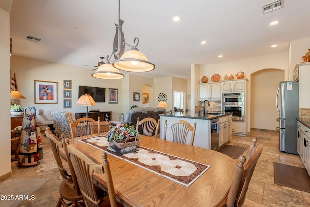 6931 S Four Peaks Way, Chandler, AZ 85249 - dining area with stone tile floors, recessed lighting, and arched walkways