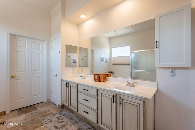 6931 S Four Peaks Way, Chandler, AZ 85249 - bathroom featuring double vanity, stone finish floors, and an enclosed shower
