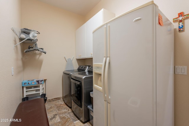 6931 S Four Peaks Way, Chandler, AZ 85249 - washroom with cabinet space, washing machine and clothes dryer, and light stone finish floors