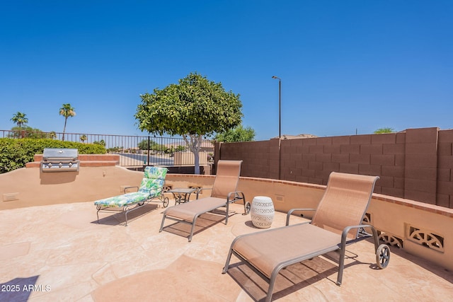 6931 S Four Peaks Way, Chandler, AZ 85249 - fenced backyard featuring a patio area and an outdoor kitchen