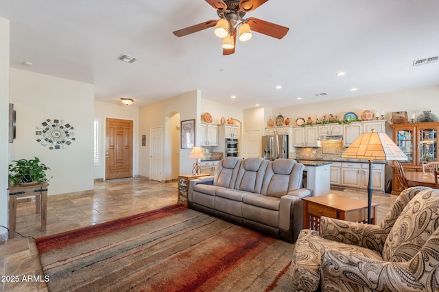 6931 S Four Peaks Way, Chandler, AZ 85249 - living room featuring a ceiling fan, recessed lighting, and light stone finish floors