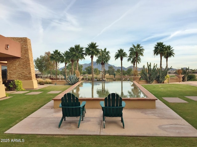 6931 S Four Peaks Way, Chandler, AZ 85249 - view of swimming pool featuring a lawn and a mountain view