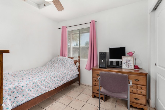 bedroom featuring light tile patterned floors, ceiling fan, and a closet