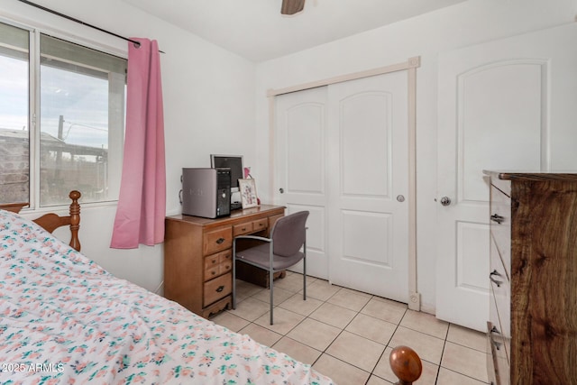 bedroom with light tile patterned floors, ceiling fan, and a closet