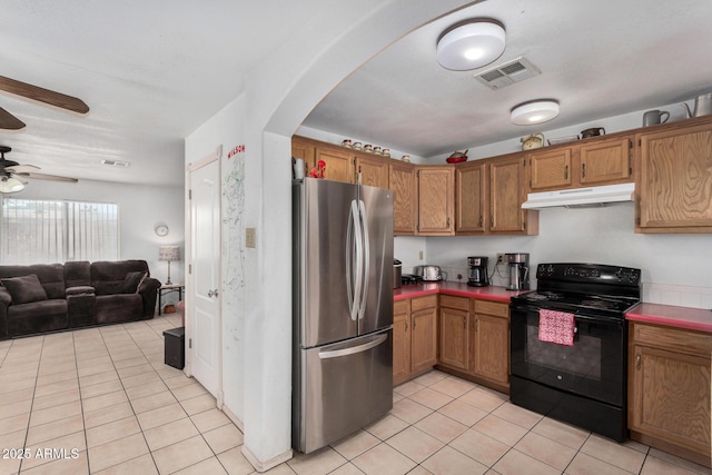 kitchen with ceiling fan, stainless steel fridge, black electric range oven, and light tile patterned floors