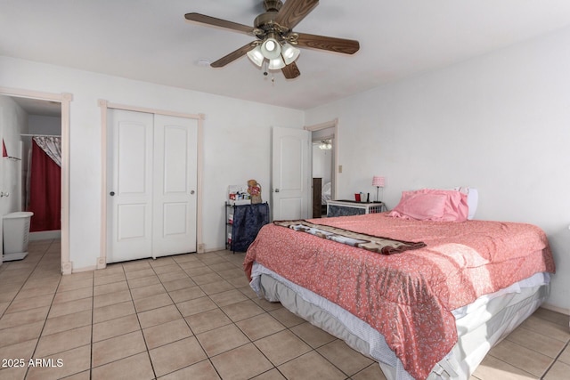 bedroom with ensuite bath, ceiling fan, and light tile patterned flooring