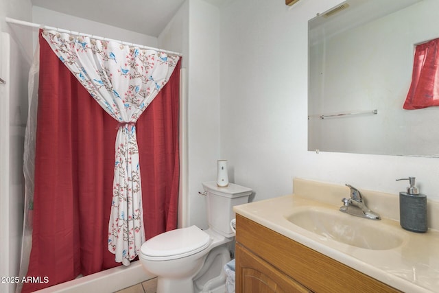 bathroom featuring vanity, toilet, and curtained shower