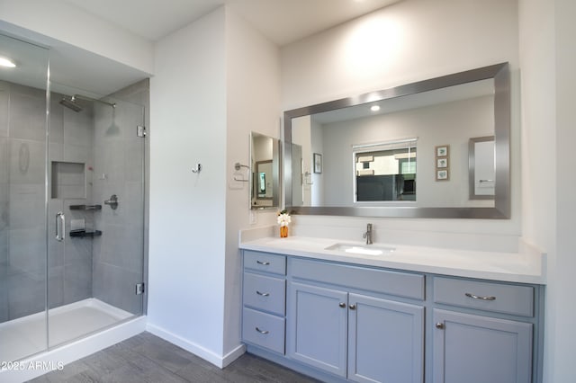 bathroom featuring vanity, hardwood / wood-style flooring, and walk in shower