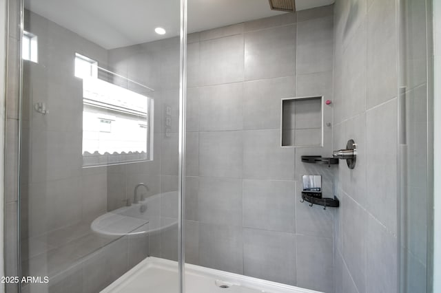 bathroom with a shower with door