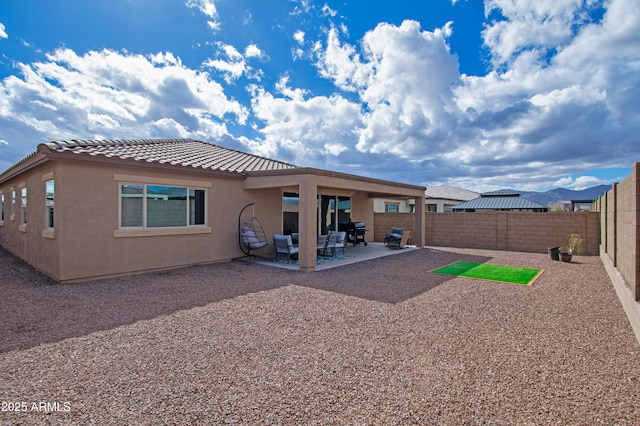 back of house with a patio