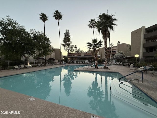 7625 E Camelback Rd Unit B241, Scottsdale, AZ 85251 - pool at dusk with a community pool and a patio