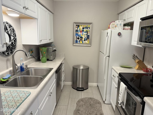 7625 E Camelback Rd Unit B241, Scottsdale, AZ 85251 - kitchen with a sink, stainless steel appliances, light countertops, white cabinetry, and baseboards