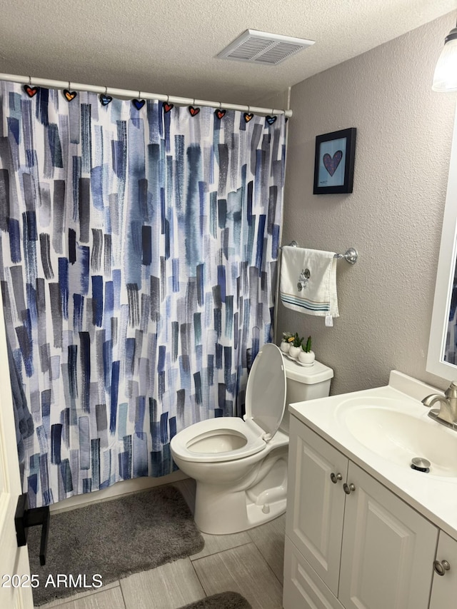 7625 E Camelback Rd Unit B241, Scottsdale, AZ 85251 - bathroom featuring toilet, vanity, a shower with shower curtain, a textured ceiling, and a textured wall