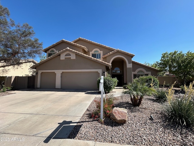 3581 W Ironwood Dr, Chandler, AZ 85226 - mediterranean / spanish house featuring a garage, driveway, stucco siding, and a tiled roof
