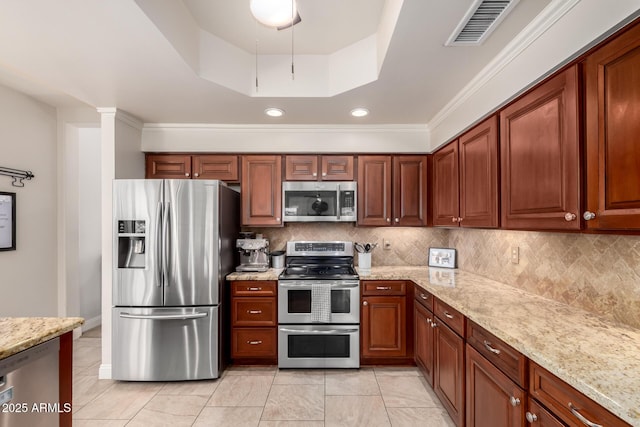 3581 W Ironwood Dr, Chandler, AZ 85226 - kitchen featuring appliances with stainless steel finishes, tasteful backsplash, light stone countertops, a raised ceiling, and crown molding