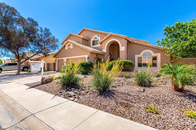 3581 W Ironwood Dr, Chandler, AZ 85226 - mediterranean / spanish-style house featuring an attached garage, driveway, stucco siding, and a tile roof