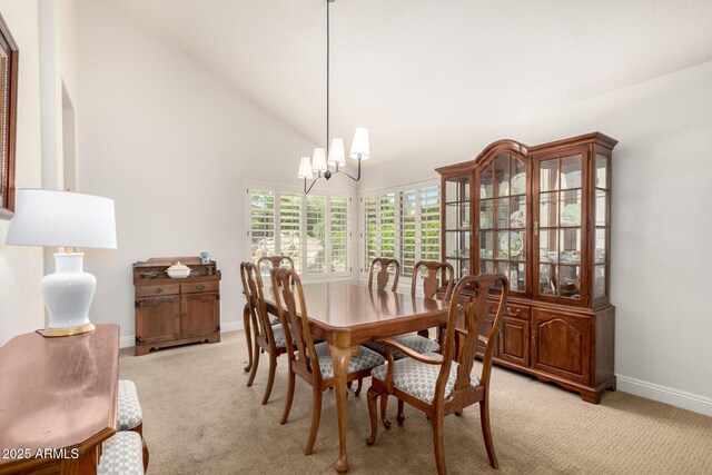 3581 W Ironwood Dr, Chandler, AZ 85226 - dining area with a chandelier, light colored carpet, baseboards, and high vaulted ceiling