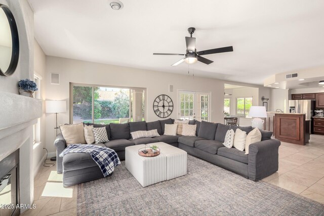 3581 W Ironwood Dr, Chandler, AZ 85226 - living area featuring ceiling fan, light tile patterned flooring, and a fireplace