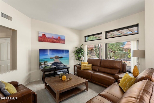 living room featuring light carpet, visible vents, and baseboards