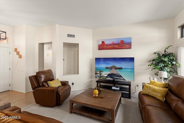 living room with visible vents and wood finished floors